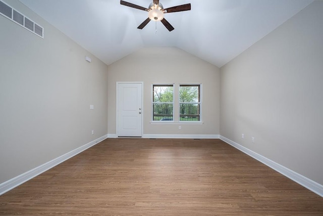 spare room with ceiling fan, vaulted ceiling, and hardwood / wood-style flooring