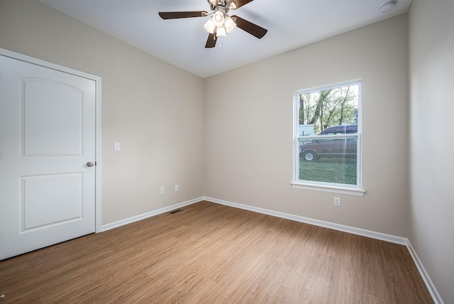 unfurnished room featuring light wood-type flooring and ceiling fan