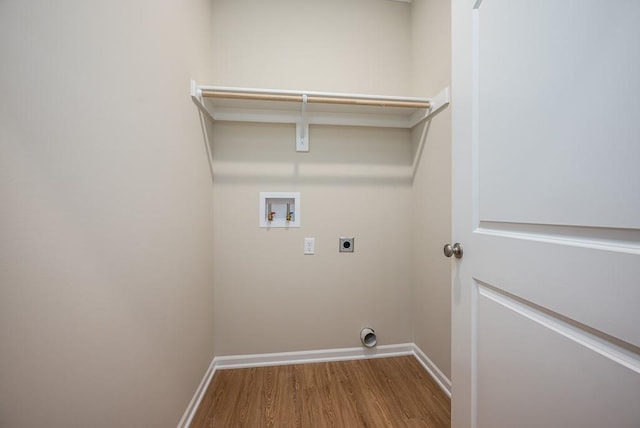 clothes washing area featuring electric dryer hookup, hookup for a washing machine, and hardwood / wood-style floors