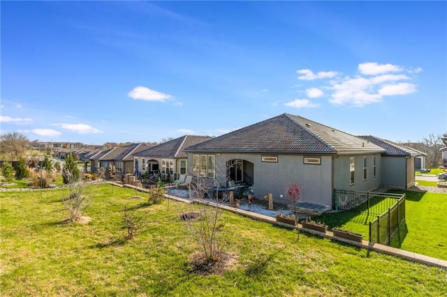 rear view of property with a yard and a patio