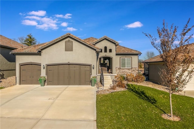 mediterranean / spanish home with a front yard and a garage