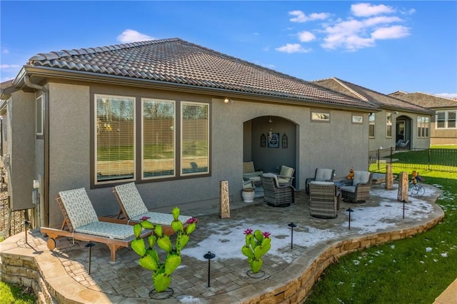 back of house featuring an outdoor living space and a patio