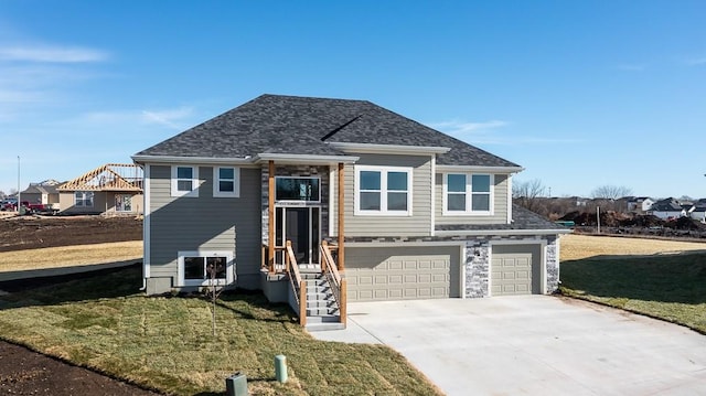 view of front of property with a front lawn and a garage