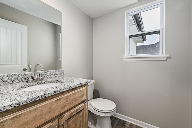 bathroom featuring hardwood / wood-style floors, vanity, and toilet