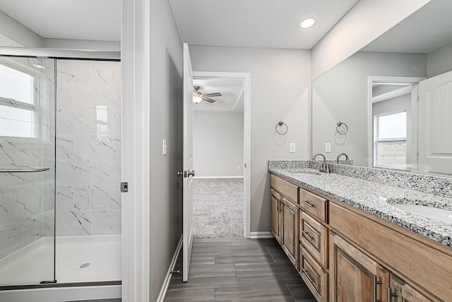 bathroom with hardwood / wood-style floors, vanity, ceiling fan, and a shower with shower door