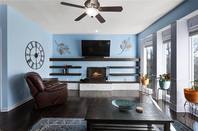 living room featuring dark hardwood / wood-style floors and ceiling fan