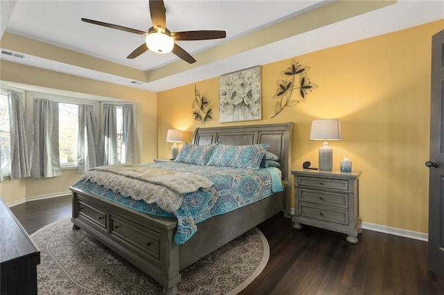 bedroom with ceiling fan and dark wood-type flooring