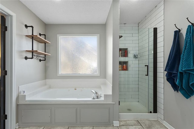 bathroom featuring tile patterned floors, separate shower and tub, and a textured ceiling