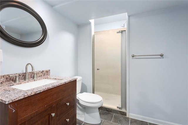 bathroom with vanity, an enclosed shower, and toilet