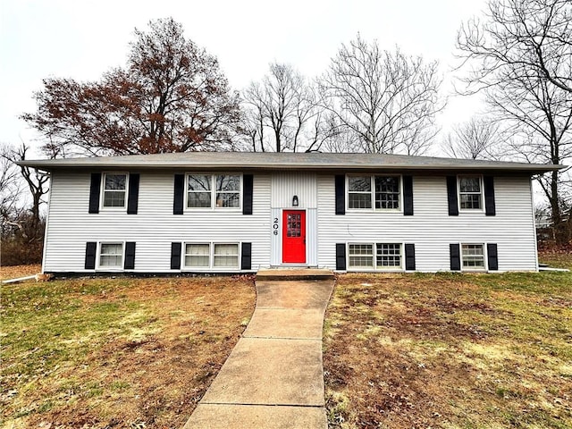 split foyer home with a front lawn