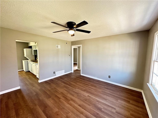 unfurnished bedroom featuring a textured ceiling, ceiling fan, and dark wood-type flooring