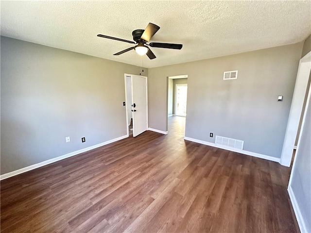 unfurnished room featuring ceiling fan, dark hardwood / wood-style floors, and a textured ceiling