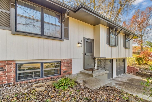 doorway to property with a garage