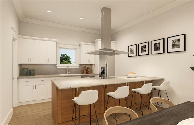 kitchen with white cabinets, sink, light wood-type flooring, island range hood, and stainless steel appliances