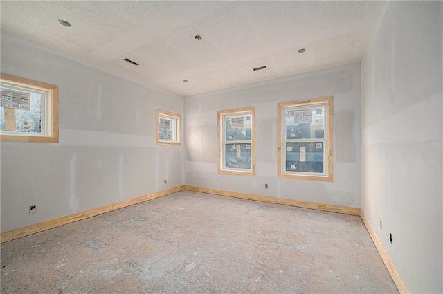 unfurnished room featuring a textured ceiling