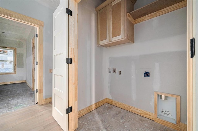 laundry area with cabinets, hookup for a washing machine, and light wood-type flooring