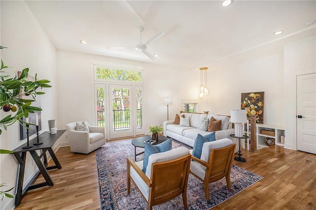 living room with recessed lighting, ceiling fan, light wood-style flooring, and baseboards