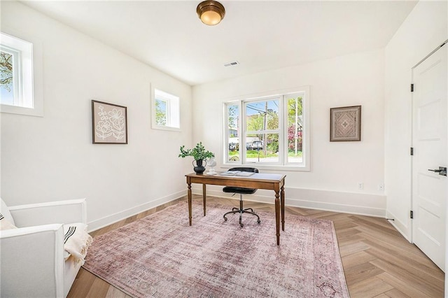 office space with visible vents and baseboards