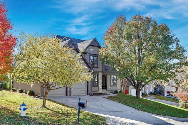 view of front of home featuring a front yard and a garage