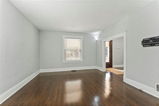 empty room featuring dark hardwood / wood-style flooring