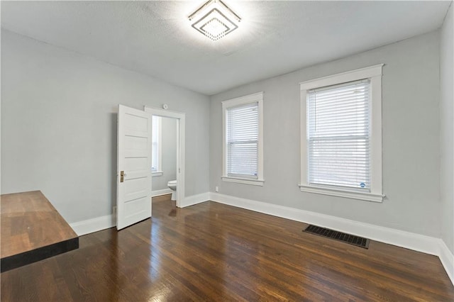 empty room featuring dark hardwood / wood-style floors