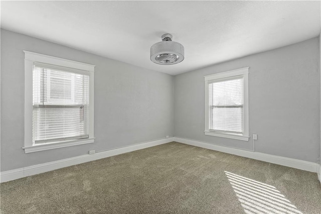 carpeted spare room featuring a wealth of natural light