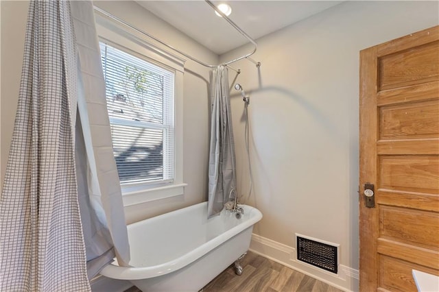 bathroom with hardwood / wood-style flooring