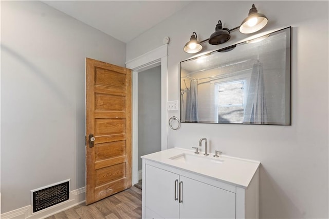 bathroom featuring hardwood / wood-style flooring and vanity