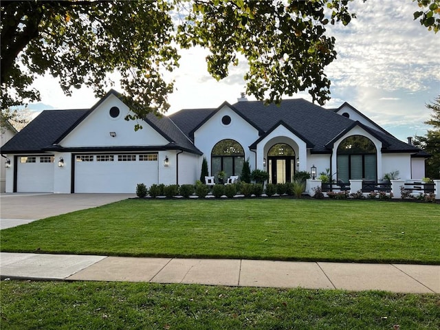 view of front facade featuring a front yard and a garage