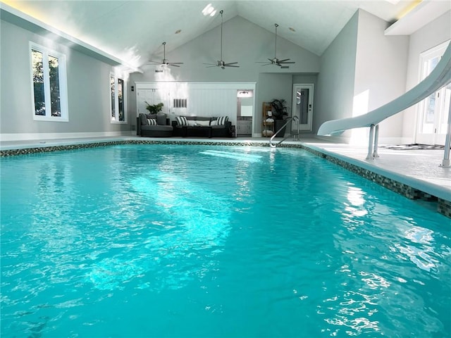 view of swimming pool with ceiling fan and a water slide