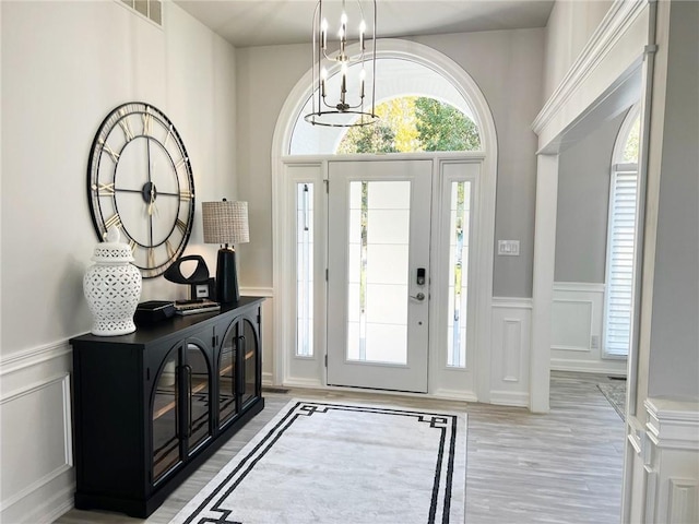 entryway featuring a notable chandelier and light wood-type flooring