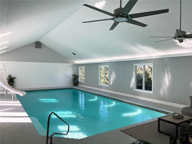 view of pool with ceiling fan and a water slide