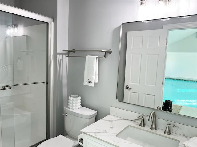 bathroom featuring vanity, toilet, and walk in shower