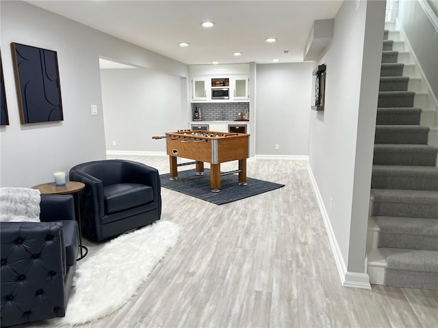 game room with light hardwood / wood-style floors