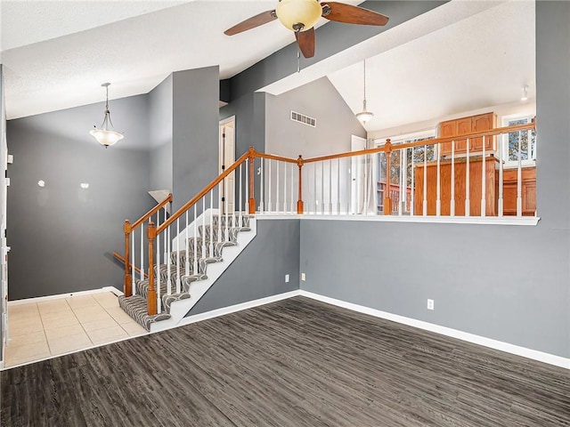 interior space with ceiling fan, high vaulted ceiling, wood-type flooring, and a textured ceiling