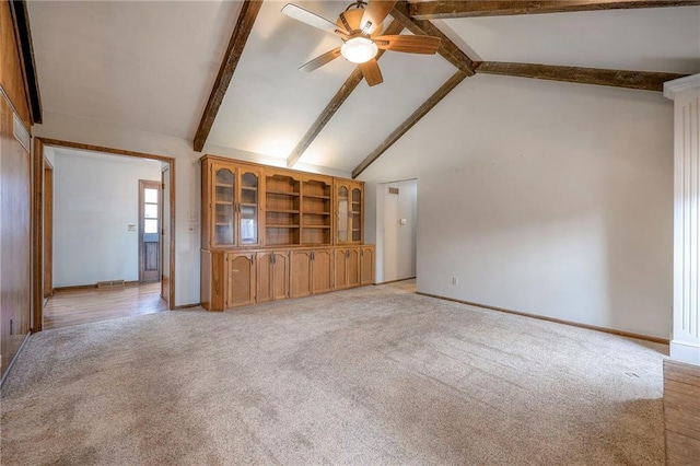 unfurnished living room featuring beamed ceiling, light colored carpet, high vaulted ceiling, and ceiling fan