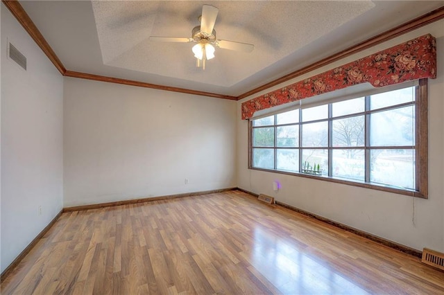 empty room featuring ceiling fan, plenty of natural light, and wood-type flooring