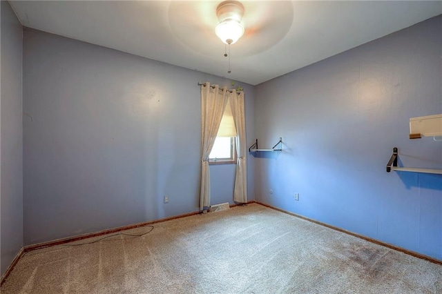 empty room featuring ceiling fan and carpet floors