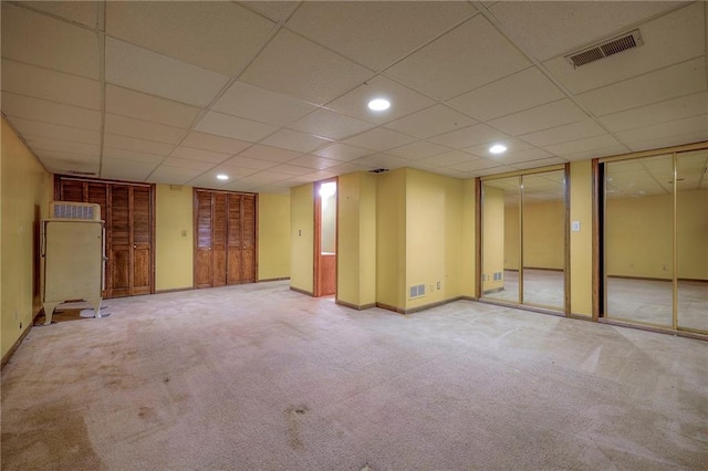 basement with carpet flooring and a drop ceiling