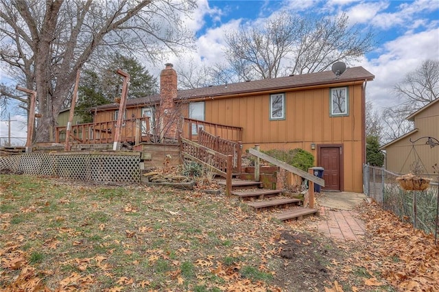 rear view of property with a wooden deck