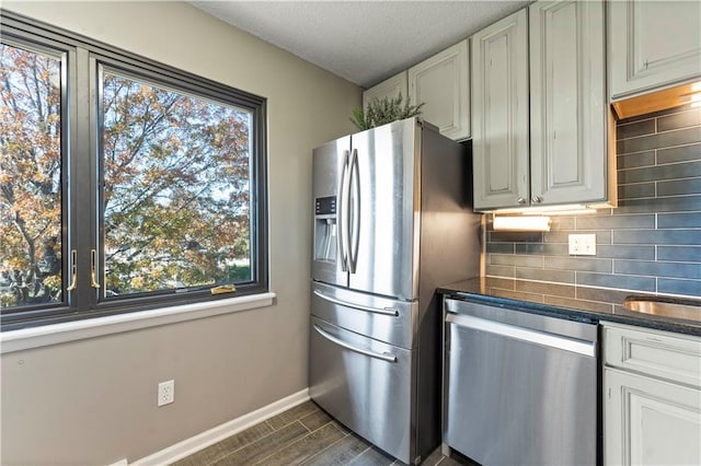 kitchen featuring a healthy amount of sunlight, dark hardwood / wood-style flooring, and appliances with stainless steel finishes