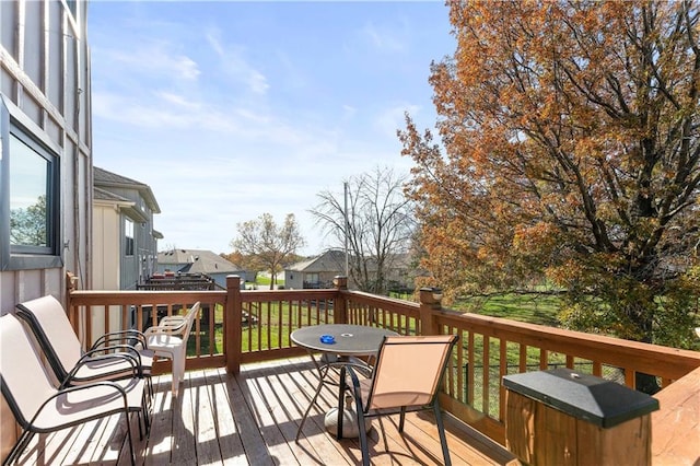 wooden terrace with a lawn