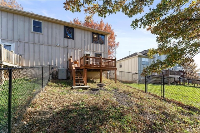 back of house featuring central air condition unit, a yard, and a deck