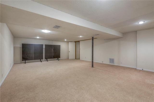 basement featuring light carpet