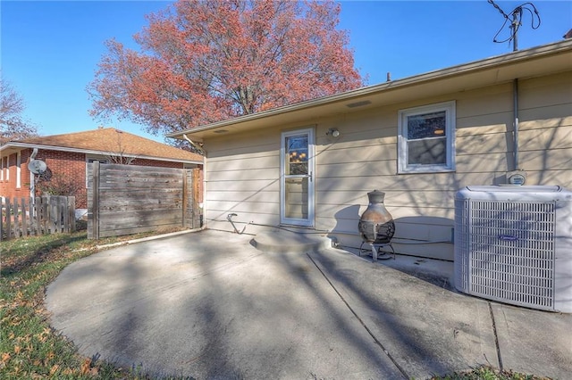 rear view of property with a patio and central AC unit