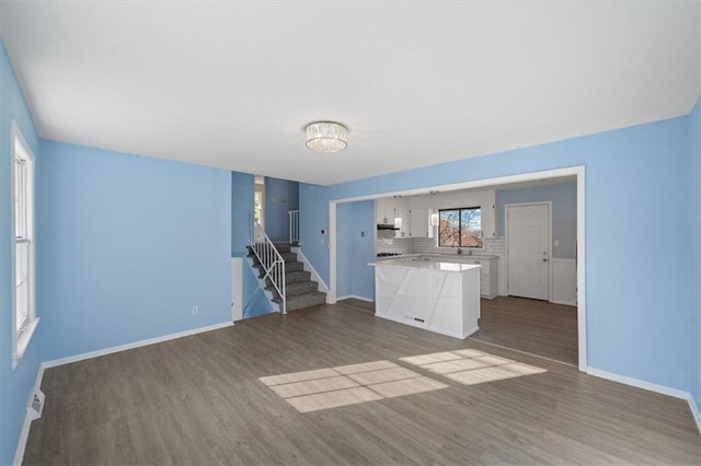 unfurnished living room with wood-type flooring