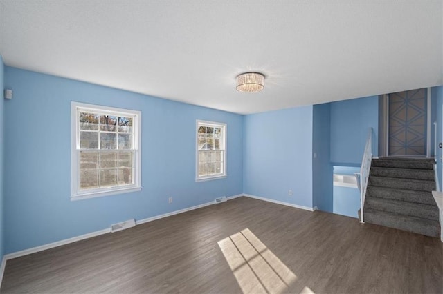 unfurnished living room featuring dark hardwood / wood-style floors