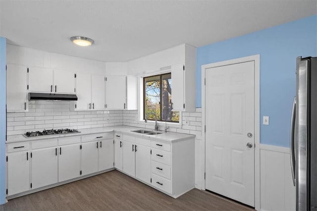 kitchen featuring dark wood-type flooring, white cabinets, stainless steel appliances, and sink