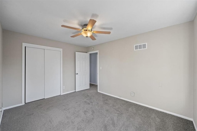 unfurnished bedroom with carpet floors, a closet, and ceiling fan