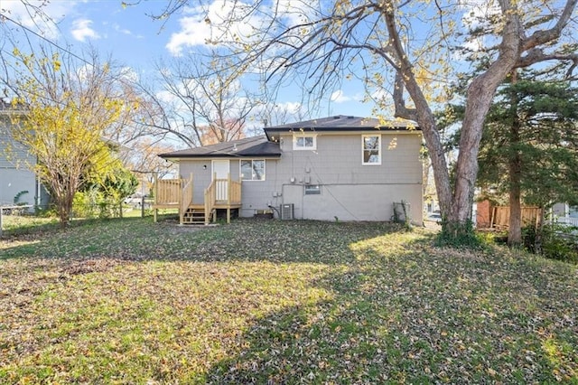 back of property featuring a wooden deck, a yard, and cooling unit